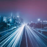 Blurred traffic on a road highway based in a well-developed city centre.