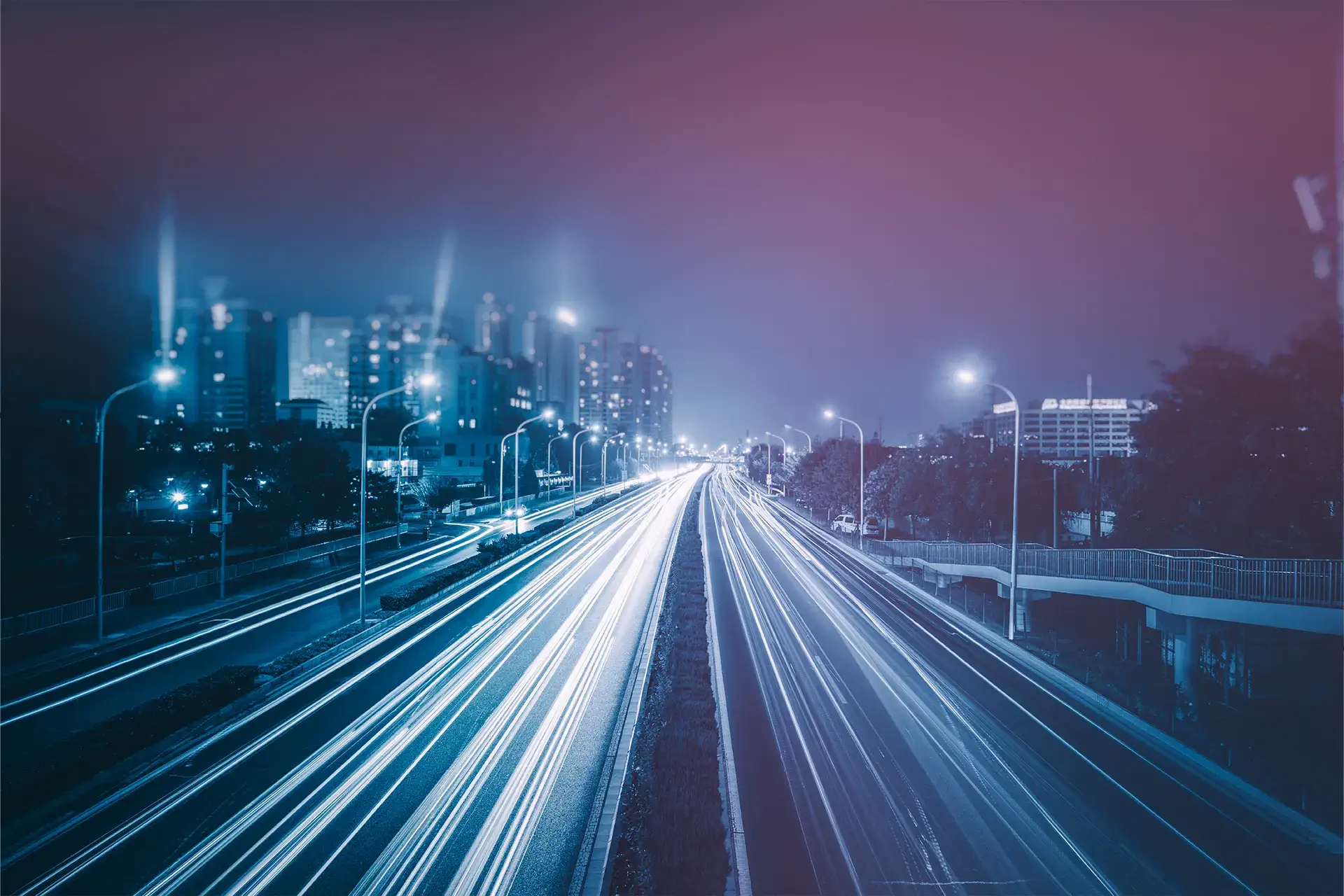 Blurred traffic on a road highway based in a well-developed city centre.