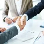 A handshake been two corporate entrepreneurs signing a contract for the first stage of Toowonba - Warwick water pipeline