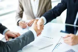 A handshake been two corporate entrepreneurs signing a contract for the first stage of Toowonba - Warwick water pipeline