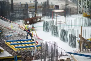 A large construction project where the worker is standing on the building in Long Island, NY