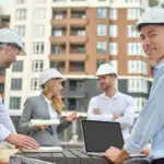 Construction professionals and researchers exploring technology solutions on a modern jobsite.